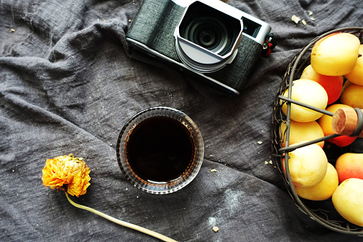 coffee, camera, fruits and flower on table