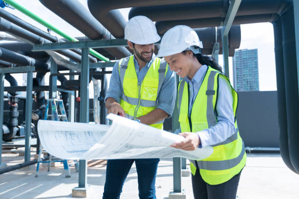 istock Engineer under checking the industry chilled water fan coil unit air conditioner is water cooling tower air chiller HVAC system of large industrial building to control air system 1405728049