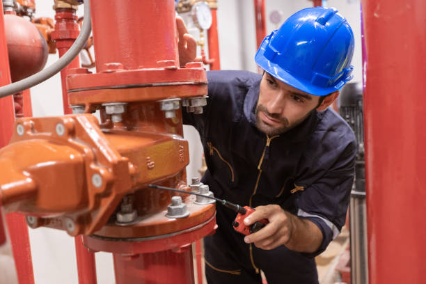 istock Engineer under checking the industry chilled water fan coil unit air conditioner is water cooling tower air chiller HVAC system of large industrial building to control air system 1405728125
