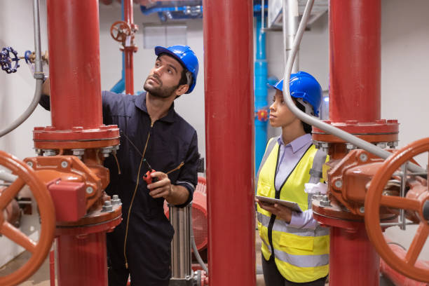 istock Engineer under checking the industry chilled water fan coil unit air conditioner is water cooling tower air chiller HVAC system of large industrial building to control air system 1405728200