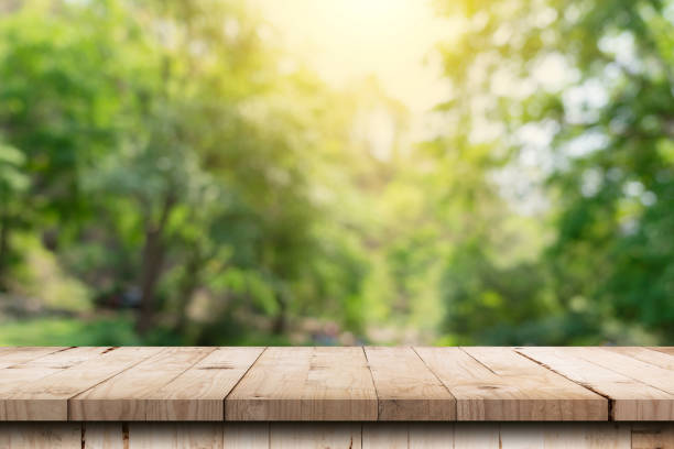 istock Wooden table and blurred green nature garden background with copy space 1405730524