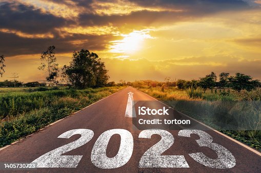 istock Empty asphalt road and New year 2023 concept. Driving on an empty road to Goals 2023 with sunset. 1405730723