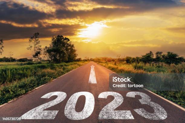 Empty Asphalt Road And New Year 2023 Concept Driving On An Empty Road To Goals 2023 With Sunset Stock Photo - Download Image Now