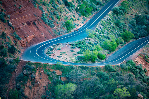 Aerial view overlooking a winding road in the Zion National Park at the Canyon Overlook. Seen a hot day in the Summer.