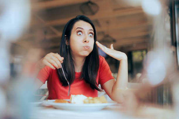 Greedy Hungry Customer Eating a too Hot Meal in a Restaurant stock photo
