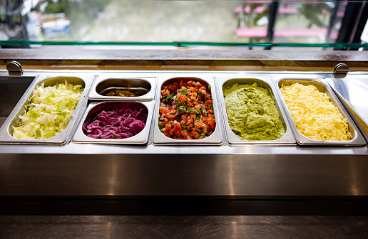 Close-up on some tacos ingredients on a salad bar at a Mexican restaurant