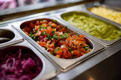 Close-up on a salad bar at a street Mexican food restaurant - food service concepts