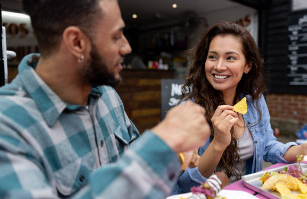 istock Loving couple on a date eating tacos at a Mexican restaurant 1405734621