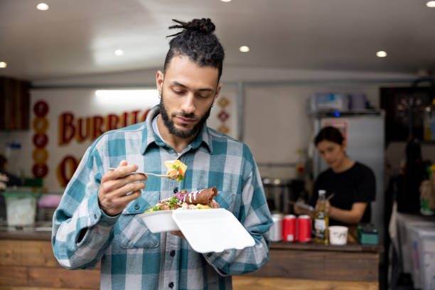 Man eating enchiladas at a small Mexican restaurant