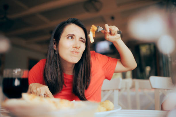 istock Exigent Woman Over Analyzing Food Course in a Restaurant 1405734772