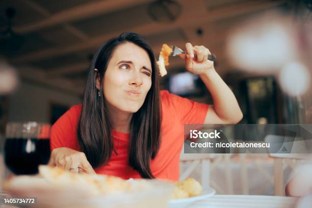 Exigent Woman Over Analyzing Food Course In A Restaurant Stock Photo - Download Image Now