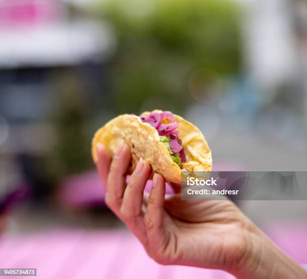 Closeup On A Woman Eating A Taco At A Mexican Restaurant Stock Photo - Download Image Now