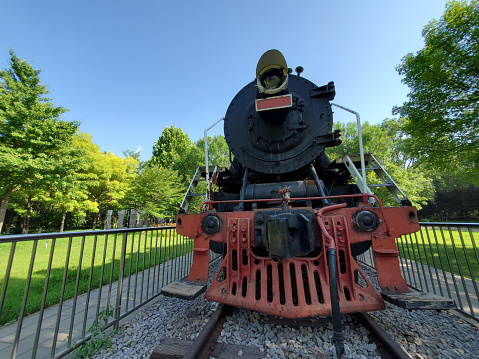 View of an outbound commuter rail train stoped at the station in Wellesley Hills, MA, a suburb of Boston, MA