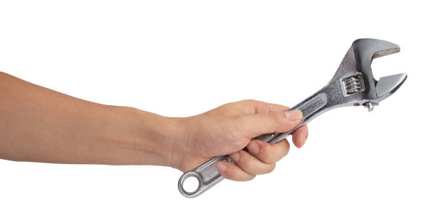 istock Man hand holding a spanner isolated on a white background 1405738089