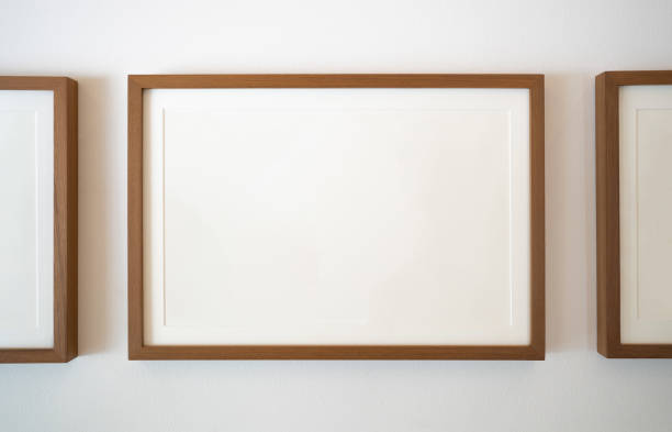 istock Wooden photo frames on white wall 1405738727