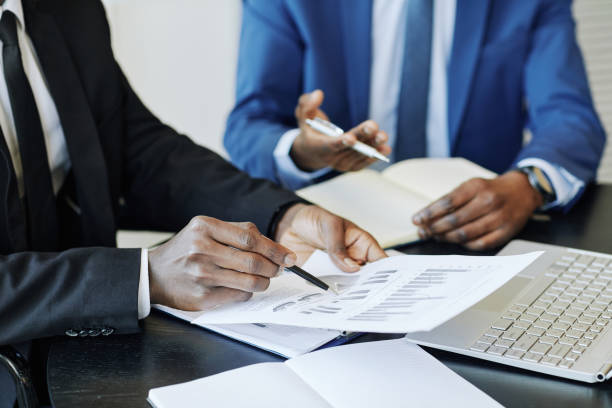 istock Businessman Pointing at Finance Report 1405739561