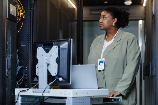 istock Black Young Woman in Server Room 1405739945