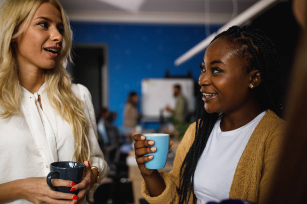 istock Two cheerful young female entrepreneurs having coffee and chatting 1405740226