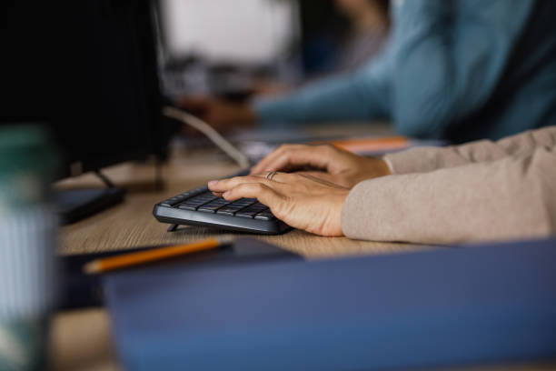 istock Businesswoman typing data on the computer keyboard, at her desk at the office 1405740899