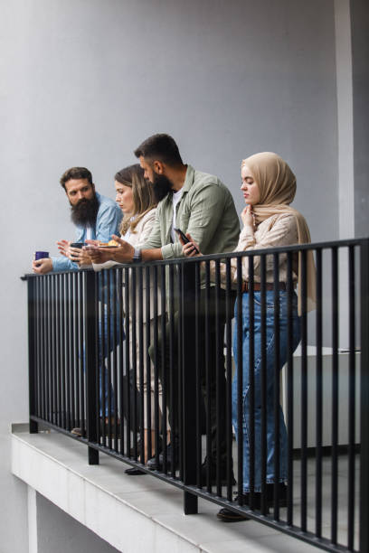 istock Small group of work colleagues relaxing on the balcony during lunch break 1405740955