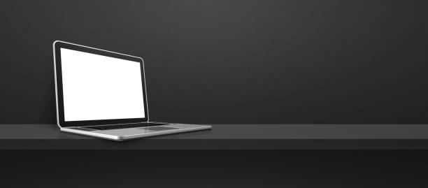 istock Laptop computer on black shelf background banner 1405742397
