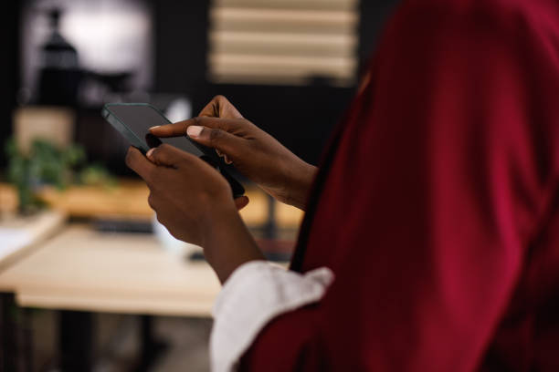 istock Businesswoman holding smart phone, tapping on the screen when scrolling through her contacts 1405748097