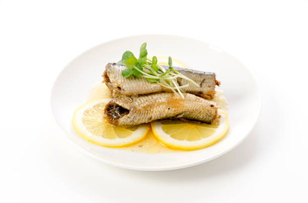 istock Sardines with slice lemon on a white plate 1405753736
