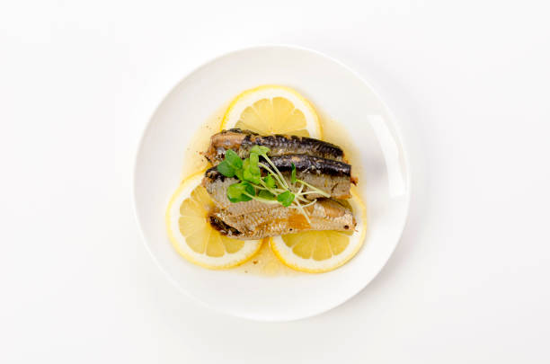 istock Sardines with slice lemon on a white plate 1405753743