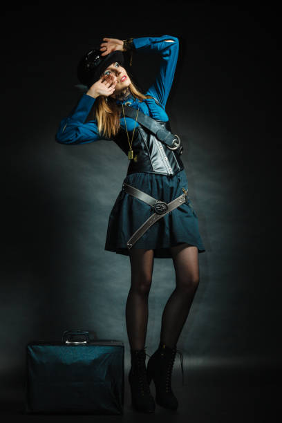 Journey and travel. Retro stylished girl with vintage big bag suitcase valise. Stylish victorian woman on dark background.