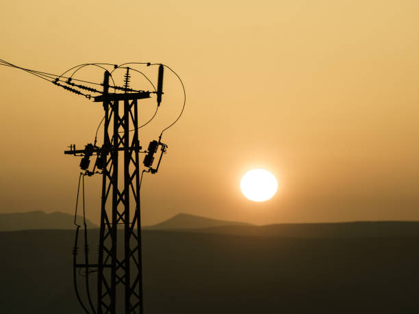 istock High voltage towers on coast at sunset 1405755050
