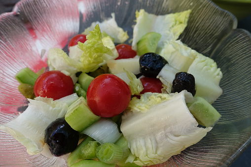 Seasoned mixed salad including cherry tomato green salad black olive endive  Meal buffet