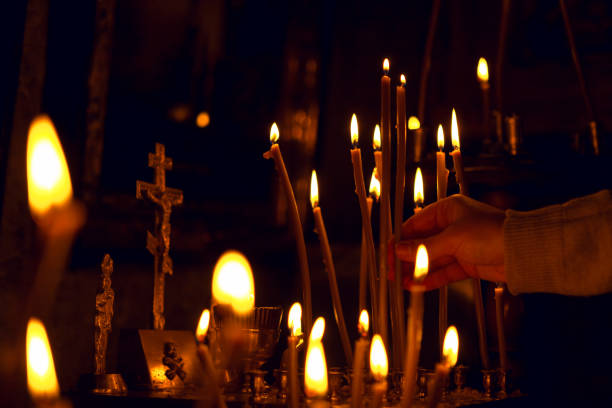 istock hand holding candle in the dark 1405757107