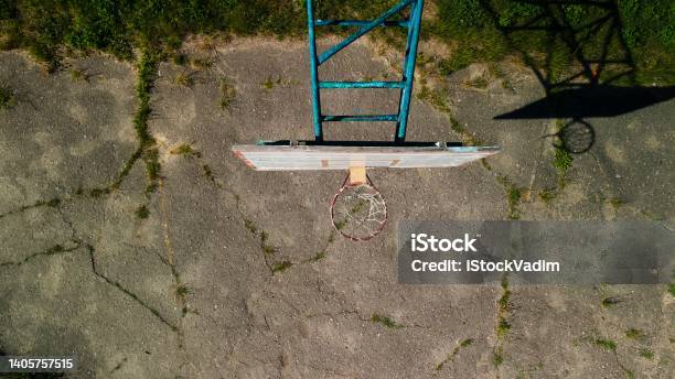 Old Basketball Backboard Made From Boards Peeling Paint And A Battered Basket There Is An Old Cracked Asphalt On The Site Shot From Above Aerial Photography Stock Photo - Download Image Now