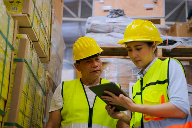 istock Blue collar worker with co worker at factory. 1405758747