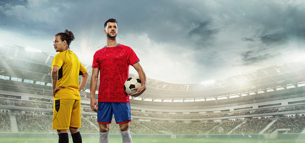 Winner and loser. Collage with two soccer, football players standing at crowded stadium during sport match on cloudy sky background. Sport competition. Action, motion, energy and dynamic concept.