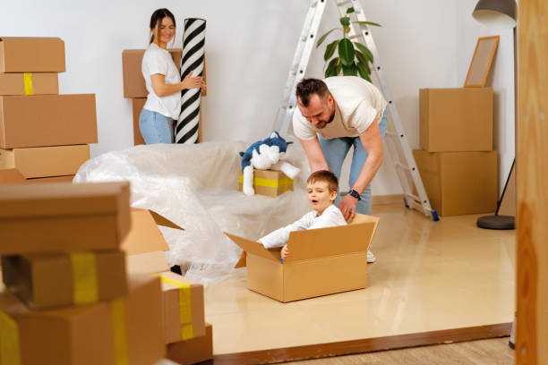 istock Parents and son packing boxes and moving into a new home 1405759122