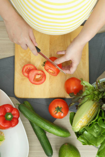 istock Pregnant woman is cooking 1405759130