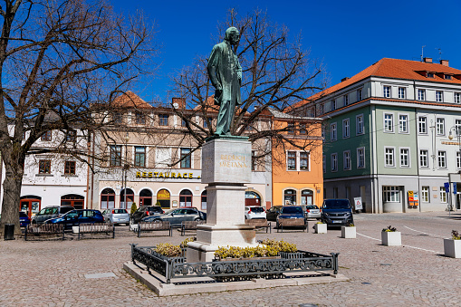 Litomysl, Czech Republic, 17 April 2022:  Smetana Square or Smetanovo namesti with medieval colorful merchant houses at sunny day, historic renaissance baroque buildings, Monument to Bedrich Smetana