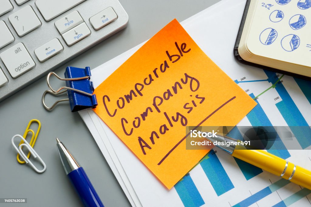 A comparable company analysis CCA report and notepad. Comparable company analysis CCA report and notepad. Accountancy Stock Photo