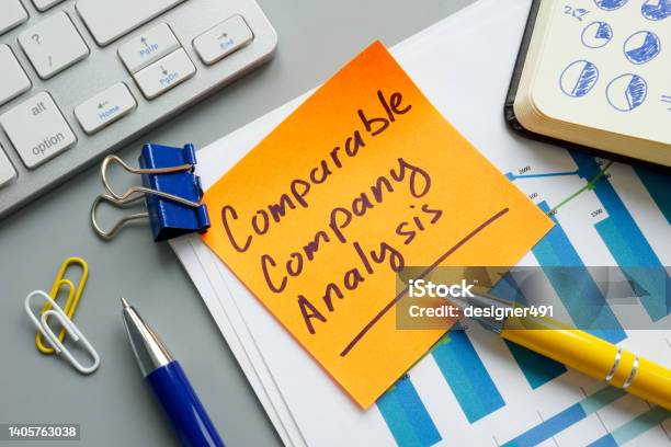 A Comparable Company Analysis Cca Report And Notepad Stock Photo - Download Image Now