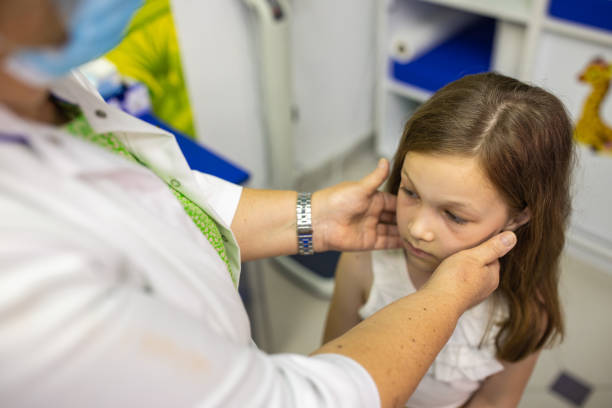 istock Doctor examining child's lymph nodes 1405765220