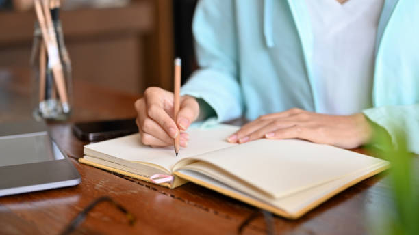 istock Cropped, closeup image A female college student doing homewor 1405765956
