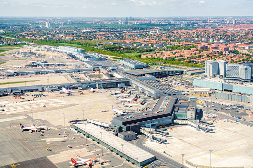 Planes from a variety of carriers on the asphalt outside the terminal buildings of Copenhagen Airport in Denmark.