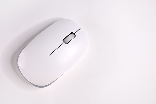 Directly above computer mouse on the white background with copy space