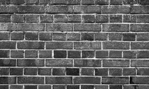 istock Old black brick wall, detailed grungy background texture 1405767494