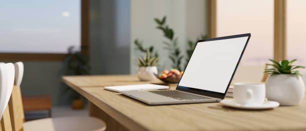 istock Modern home workplace with notebook laptop and decor on wood dining table in living room 1405768310