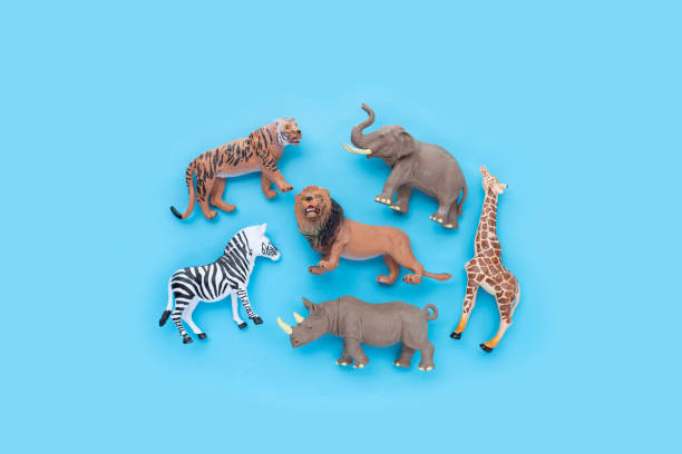 istock Plastic jungle animal toys on blue background. 1405769109