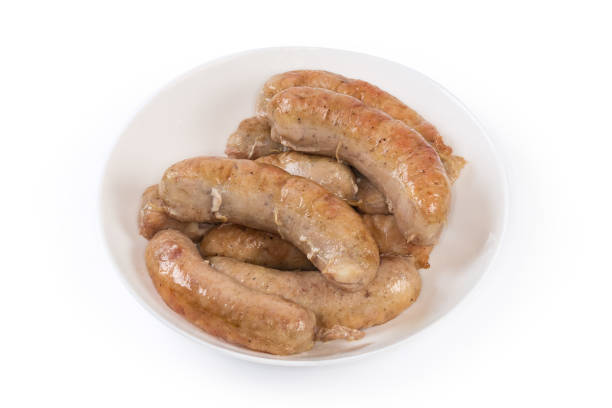 istock Baked chicken sausages in bowl on a white background 1405770309