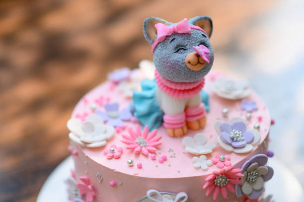 istock Festive pink cake with a cat on top. 1405770584