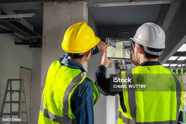 Engineer Architect And Construction Supervisor Use Tablet To Record Information While Inspecting Construction Work Construction Supervisor Architect Or Engineer Inspect Construction Inside Building Stock Photo - Download Image Now